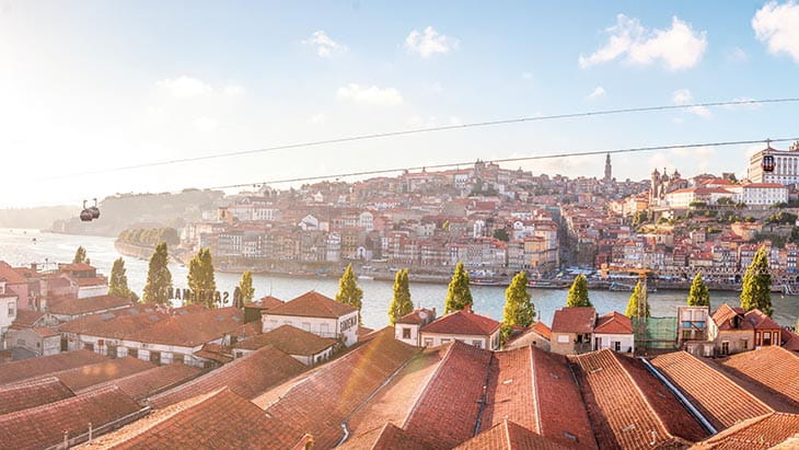 A view over the rooftops of Oporto beside the Douro River at dusk